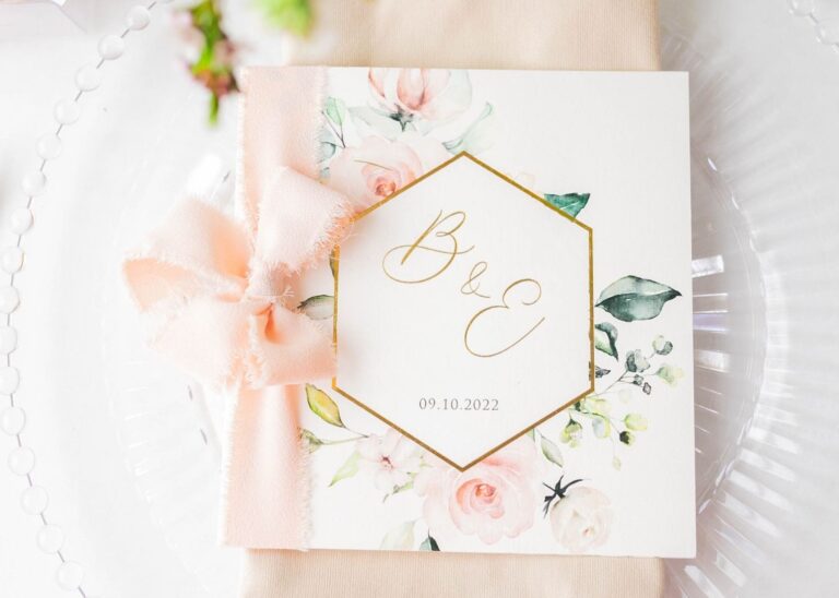 Beautiful calligraphy script monogram on a floral wedding program created with Canva