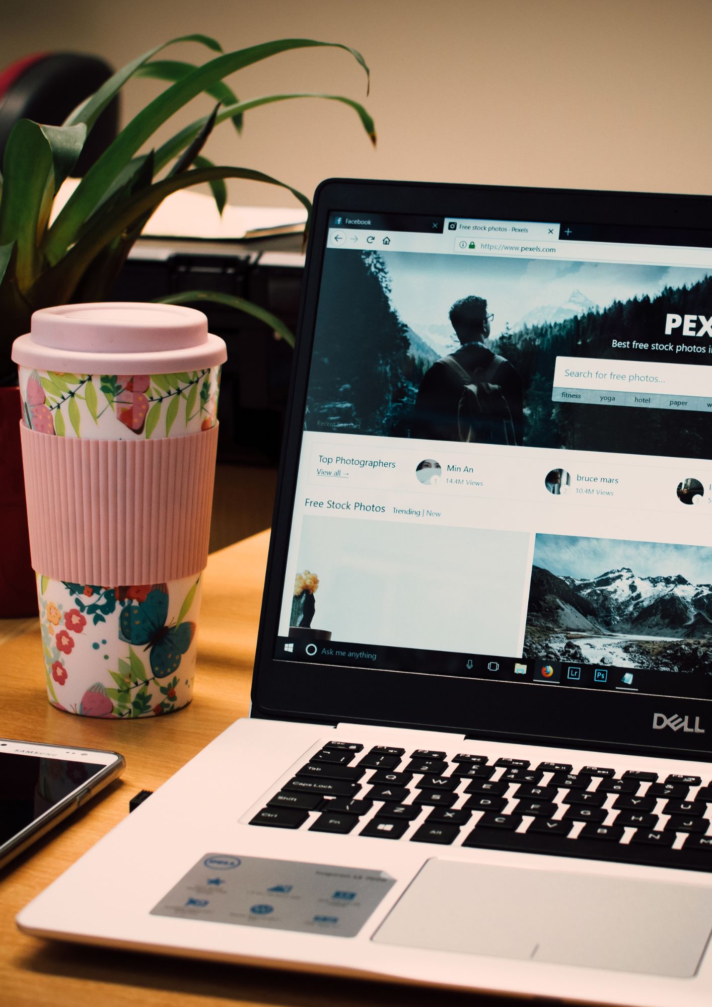 Laptop next to a cup of coffee
