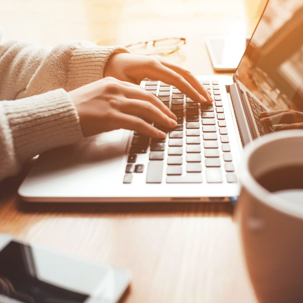 woman typing on a laptop
